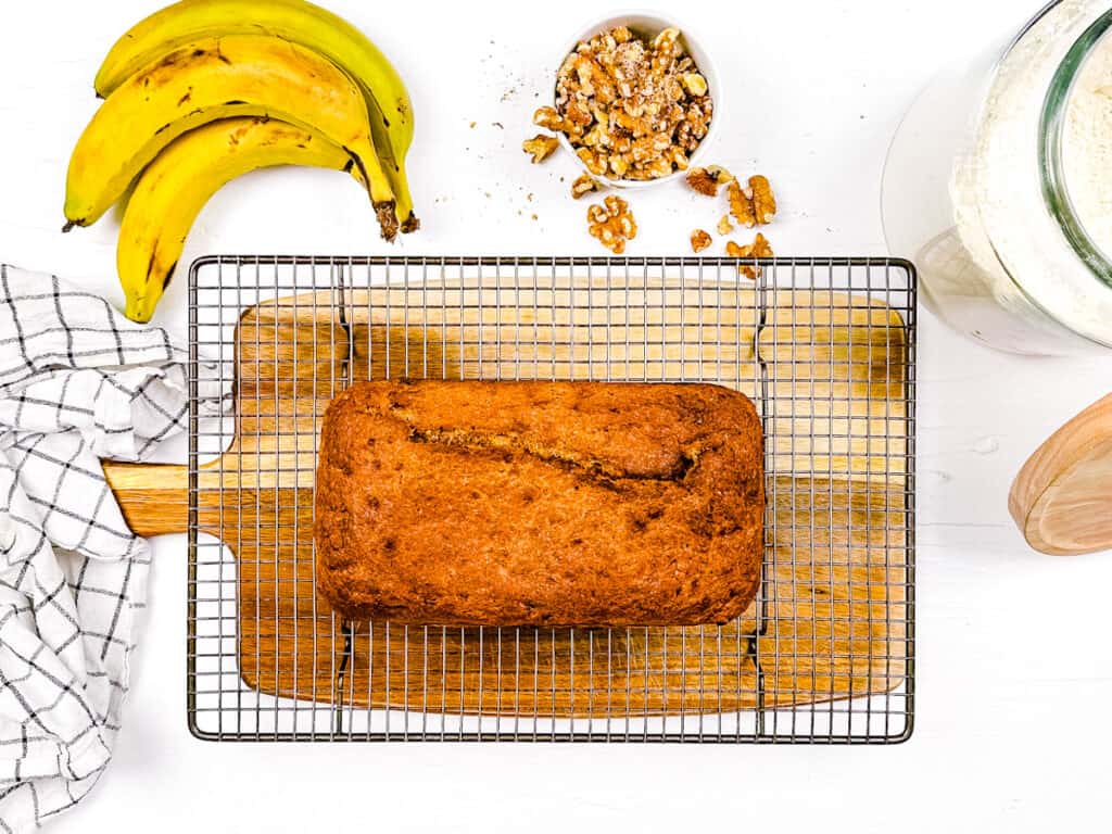 Banana bread with oil, no butter cooling on a wire rack.