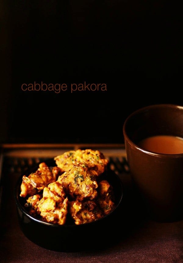 cabbage pakoda served on a black bowl with tea