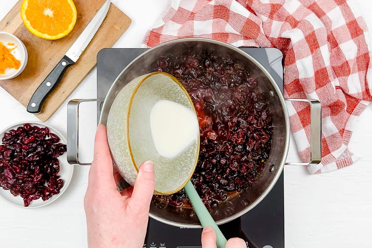 Adding cornstarch to the cranberry sauce to thicken it up.