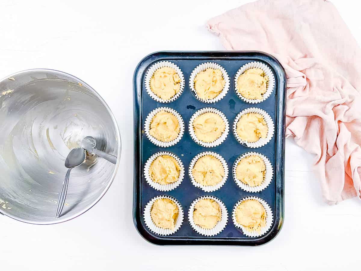 Cupcake batter added to a prepared cupcake pan, ready to go into the oven.