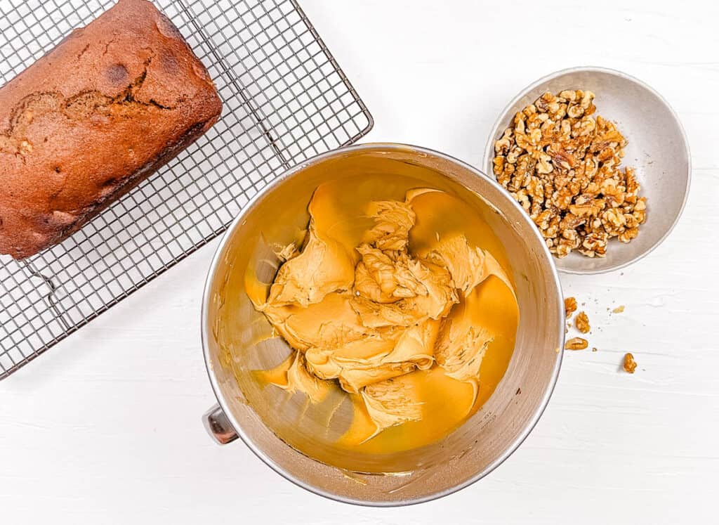 Icing for walnut loaf mixed in a mixing bowl.