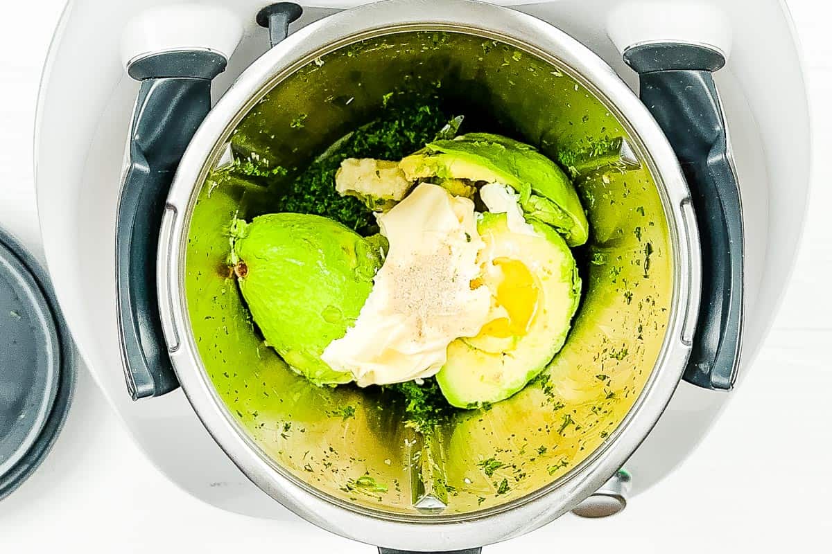 Avocado and yogurt along with seasonings are added to the blender. 