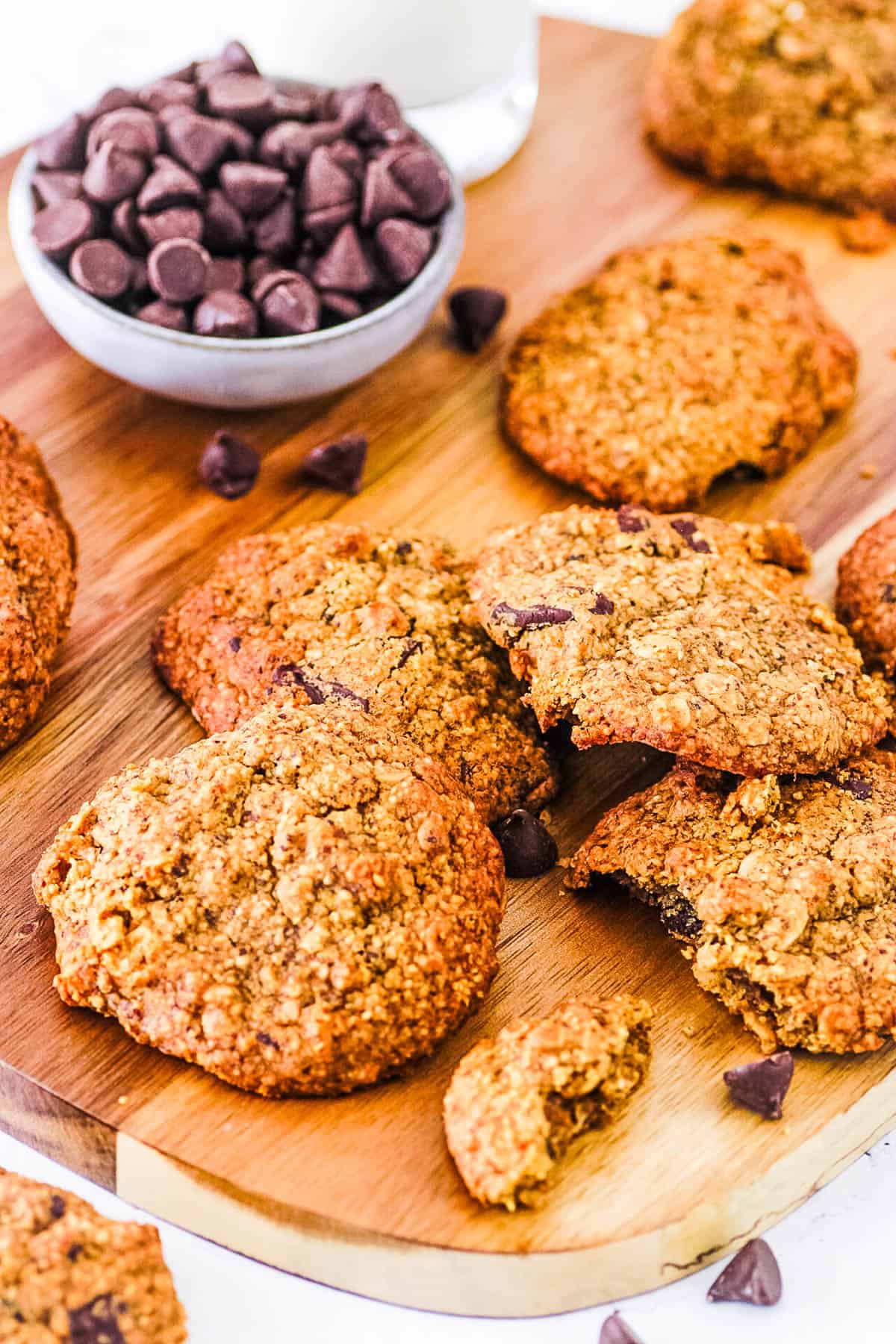 Healthy, vegan, gluten free lactation cookies stacked on a wooden cutting board.