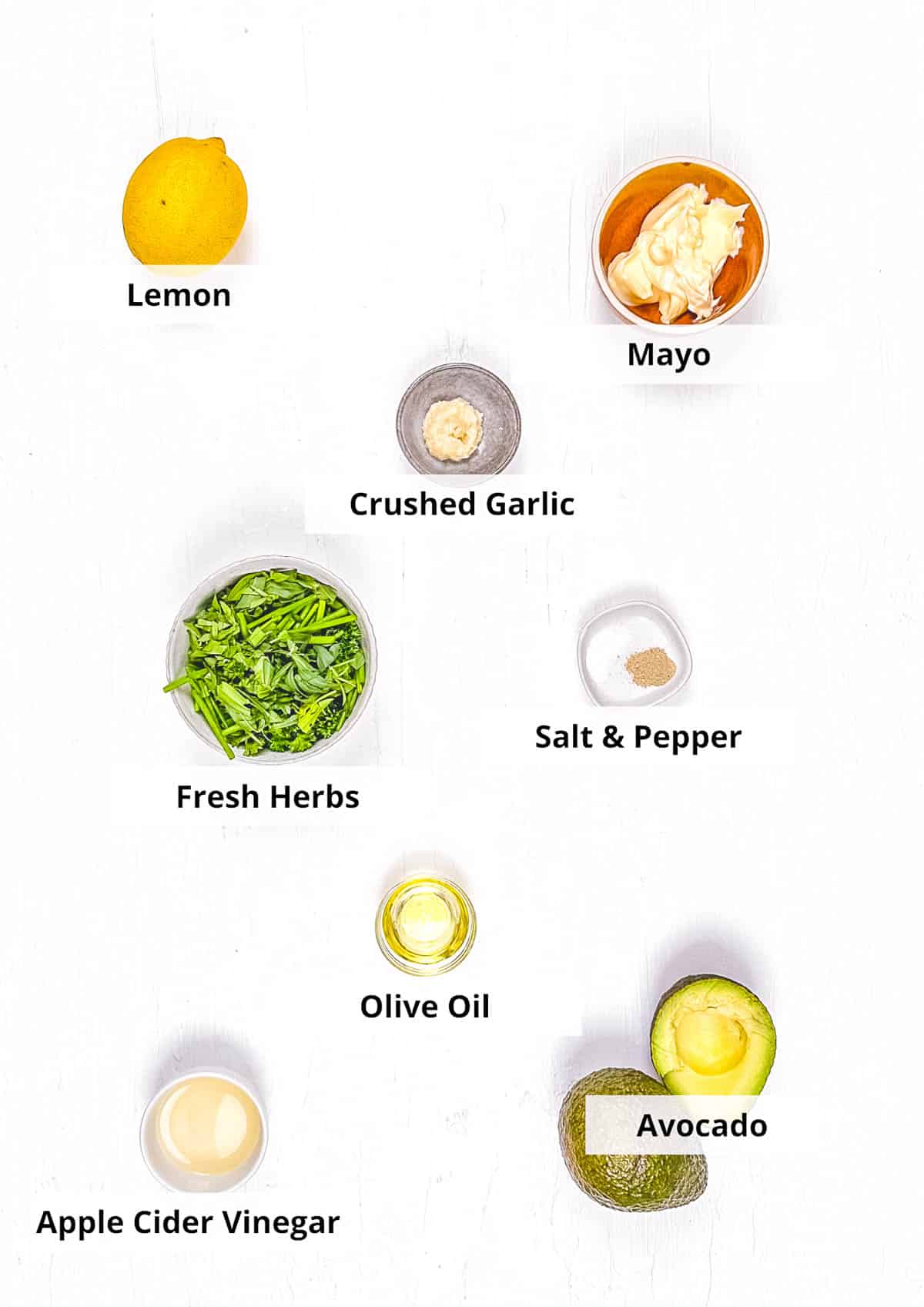 Ingredients for avocado green goddess dressing recipe on a white background.