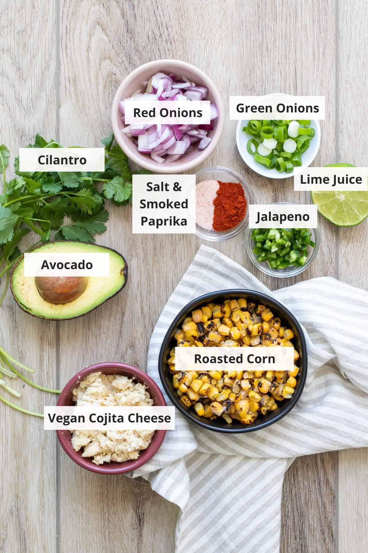Ingredients for elote street corn salad recipe on a wood countertop.