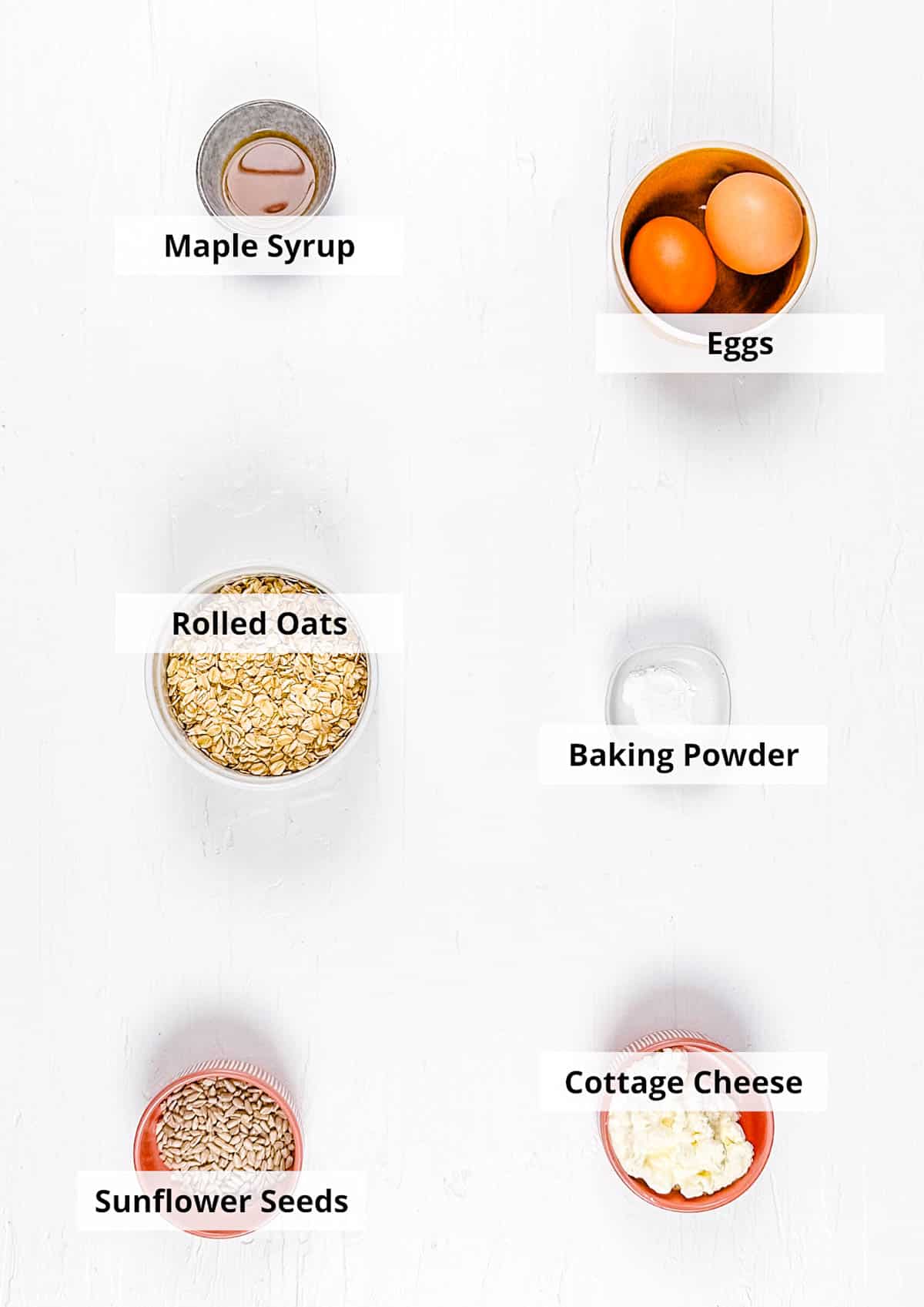 Ingredients for healthy oat flour pancakes on a white background.