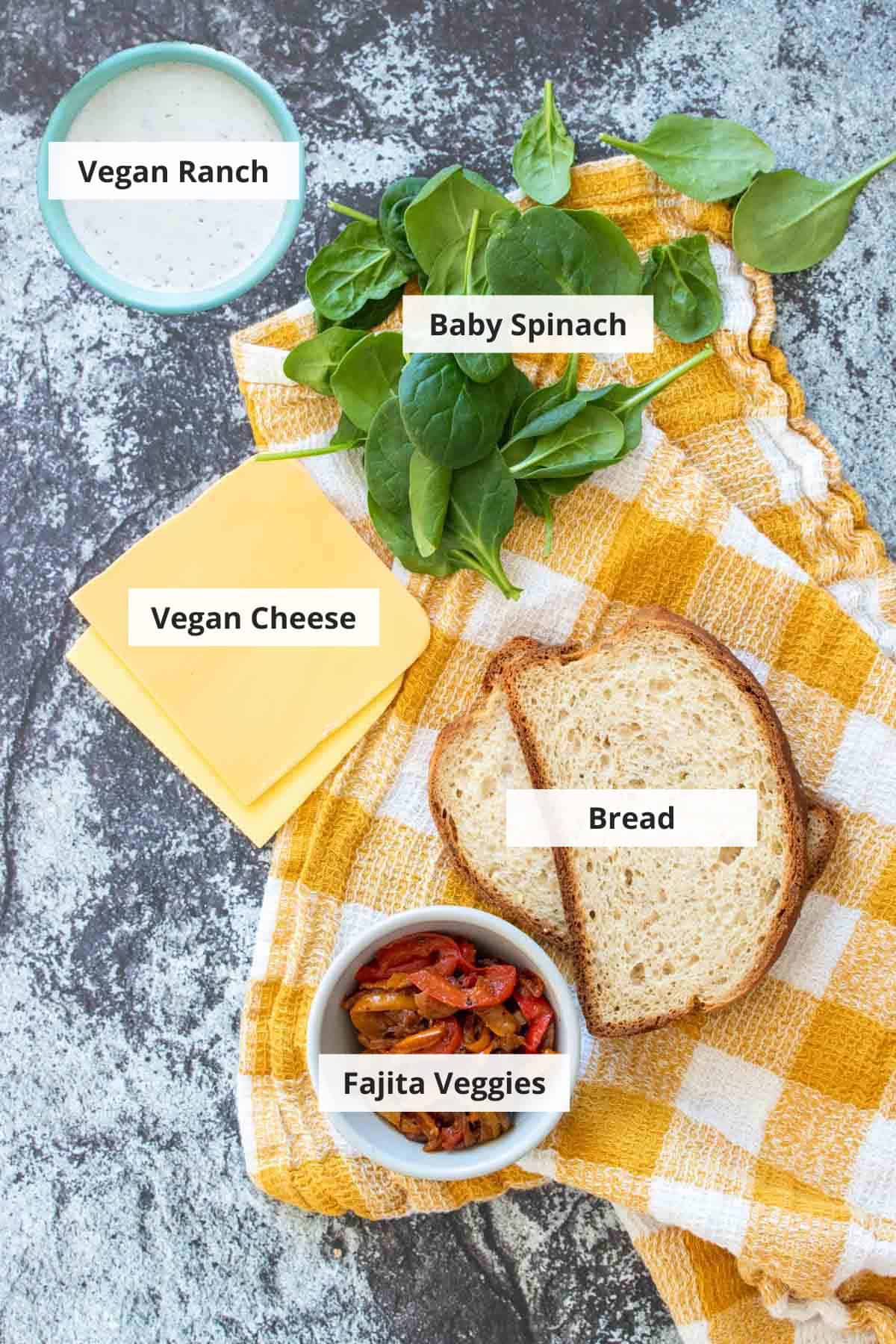 Ingredients for vegan grilled cheese sandwiches on a grey background.
