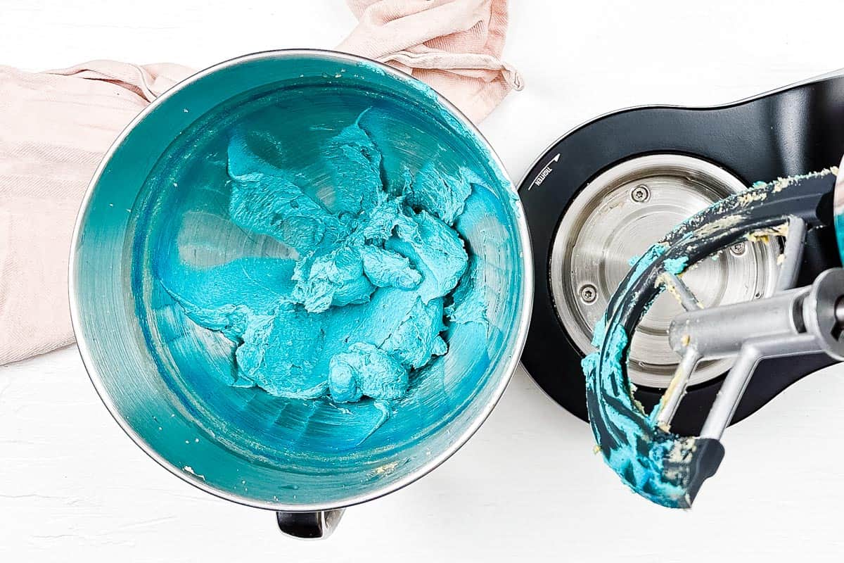 Blue food coloring makes the butter and sugar mixture vibrant blue in the stand mixer bowl. 
