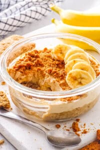 Easy overnight Weetabix, topped with sliced bananas, served in a glass bowl.