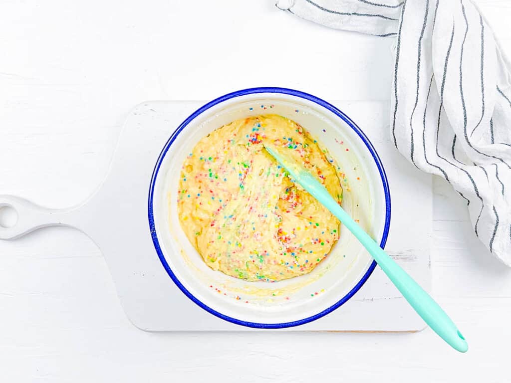 Batter for sprinkle muffins in a mixing bowl.