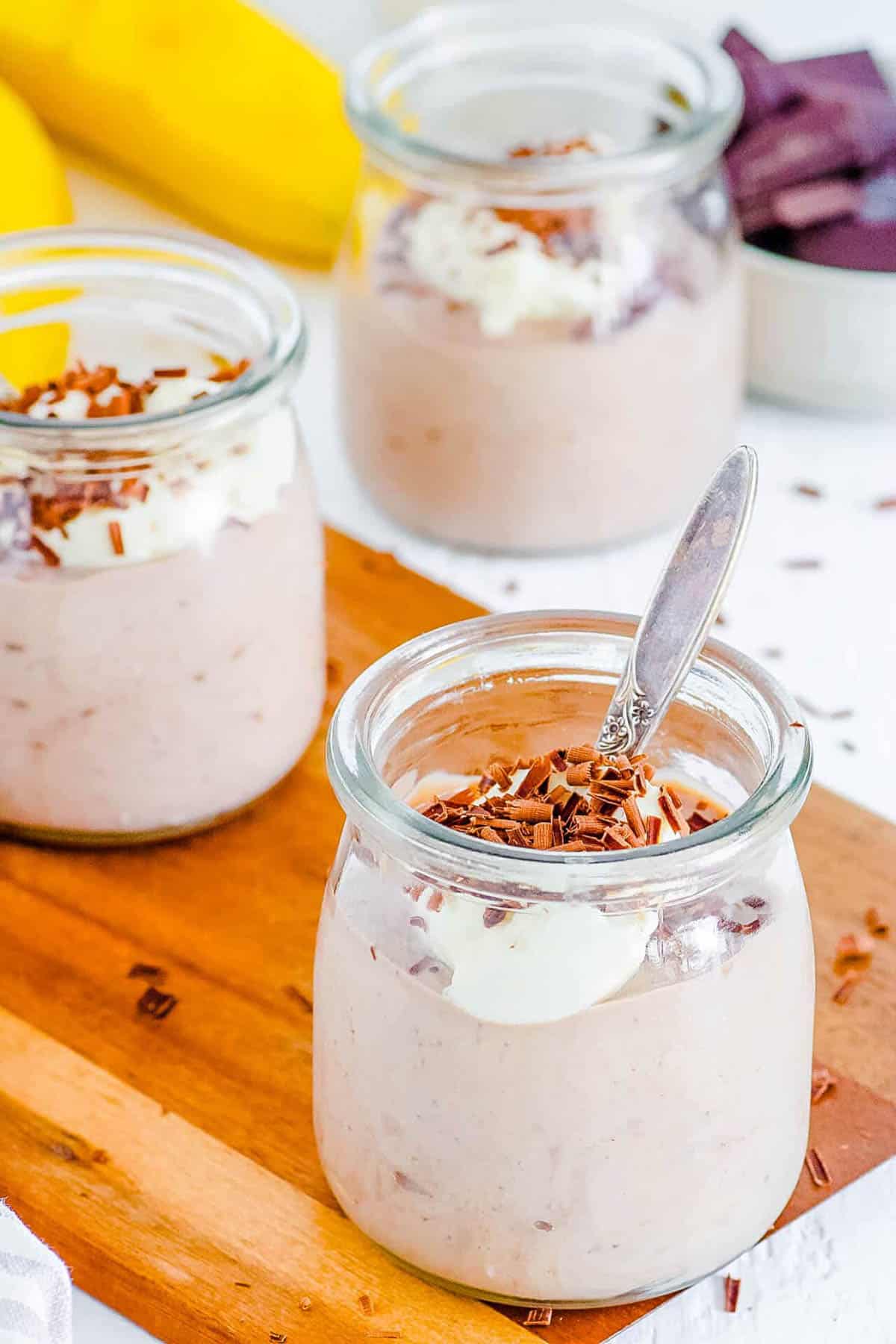 Healthy desserts including tofu chocolate mousse on a wooden cutting board.