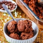 Scoops of tofu ice cream in a small white bowl with a metal spoon.