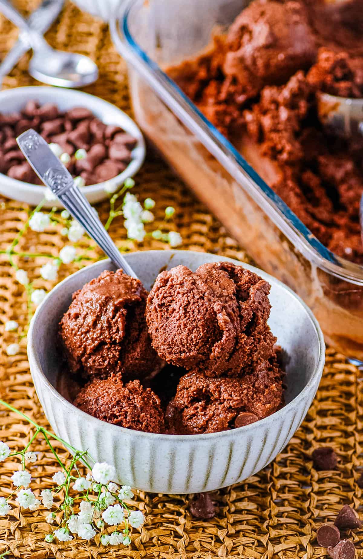 Scoops of tofu ice cream in a small white bowl with a metal spoon.