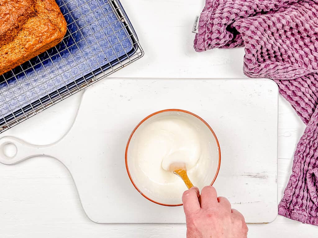 Vanilla glaze being mixed in a mixing bowl.