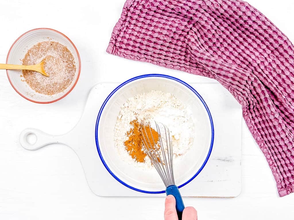 Dry ingredients for quick bread mixed in a bowl.