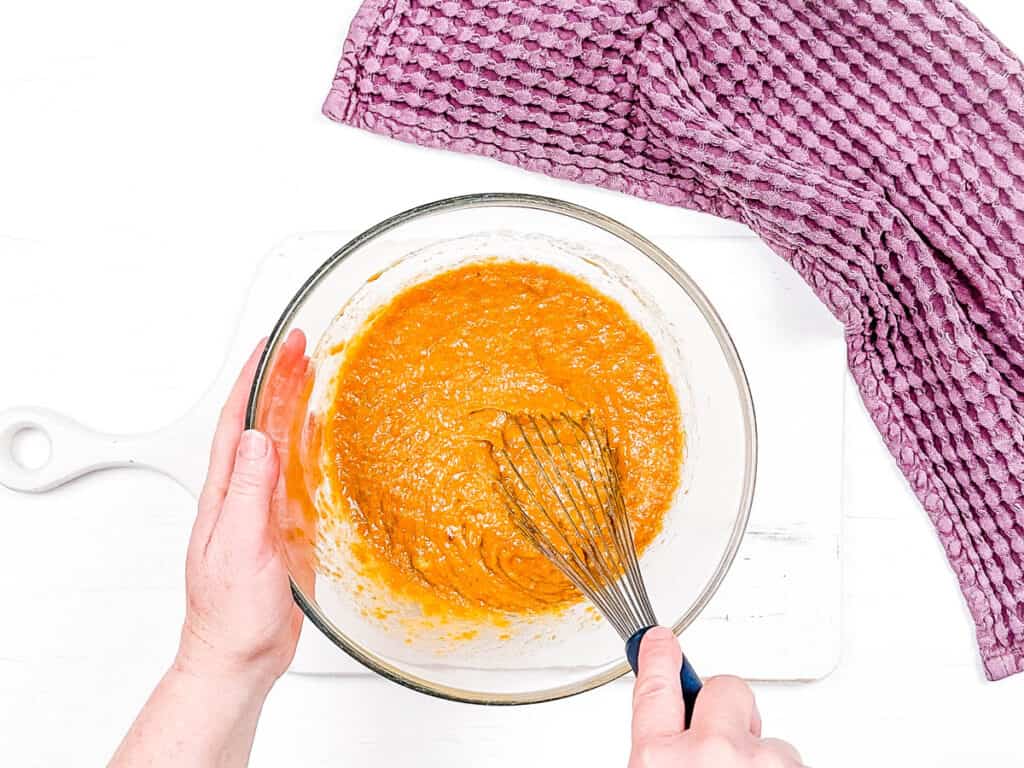 Wet ingredients for quick bread mixed in a bowl.