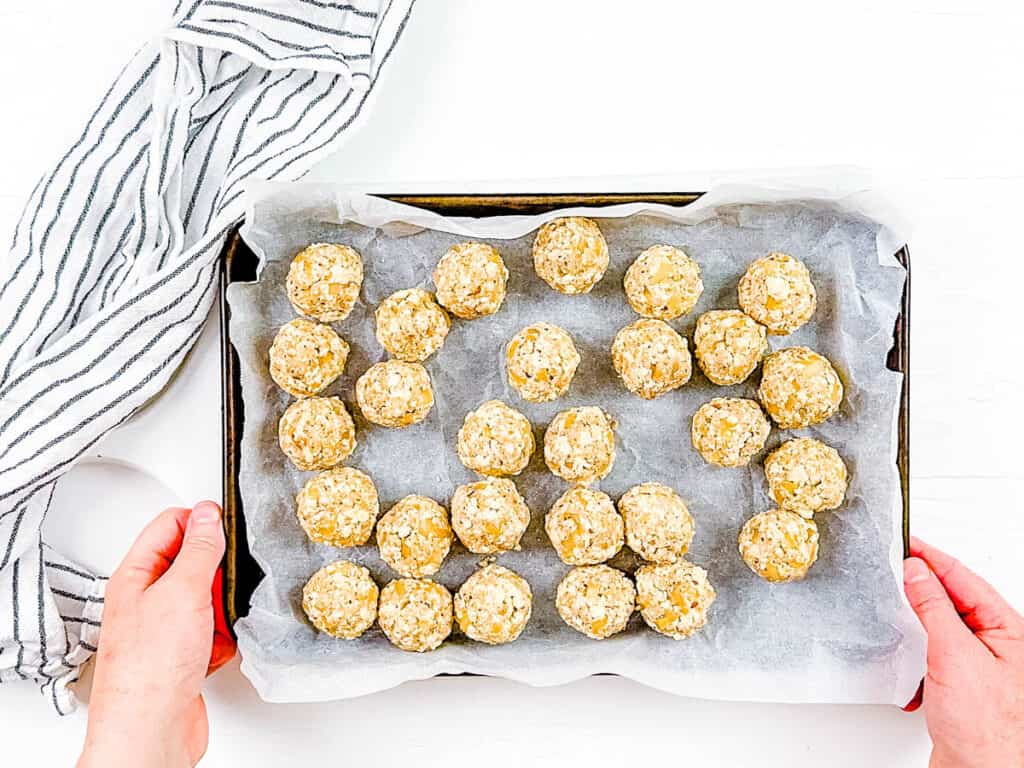 Vegan meatballs on a baking sheet lined with parchment paper.