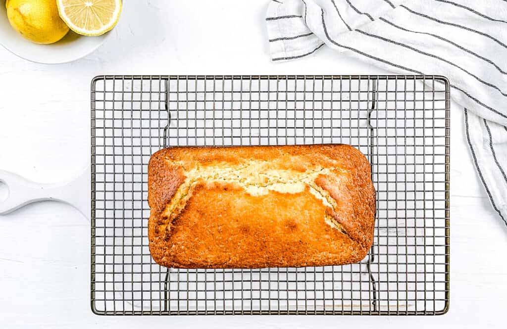 Vegan lemon olive oil loaf cooling on a wire rack.