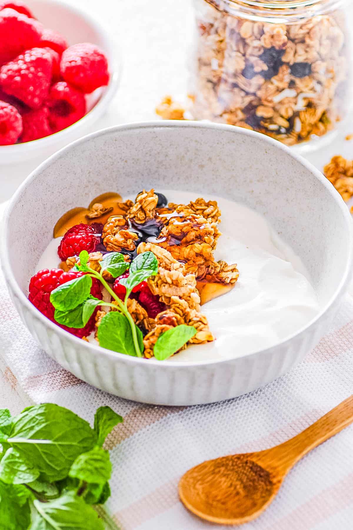 Creamed cottage cheese with honey, granola and fruit in a bowl.