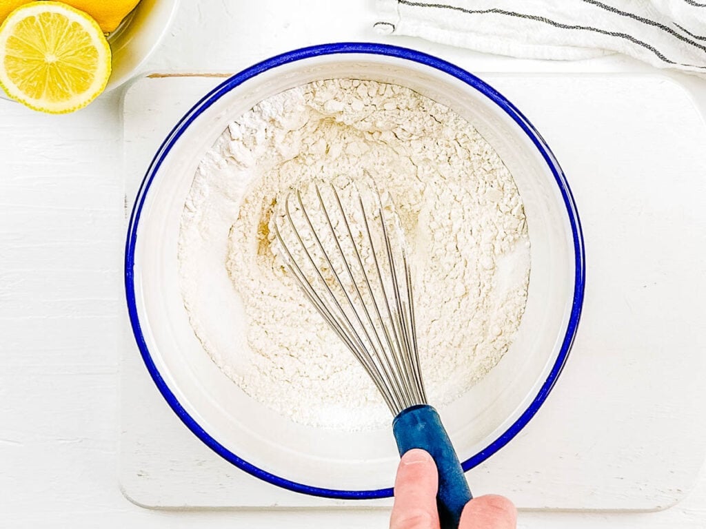 Dry ingredients for cake mixed in a mixing bowl.