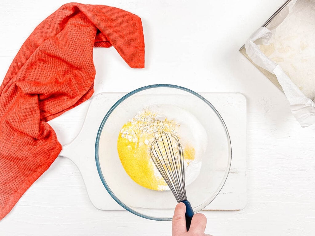 Cornmeal and gluten free flour mixed in a bowl.