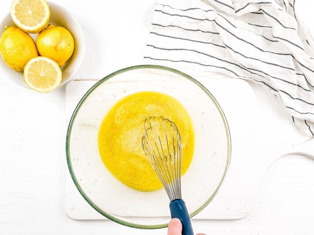 Wet ingredients for cake mixed in a mixing bowl.