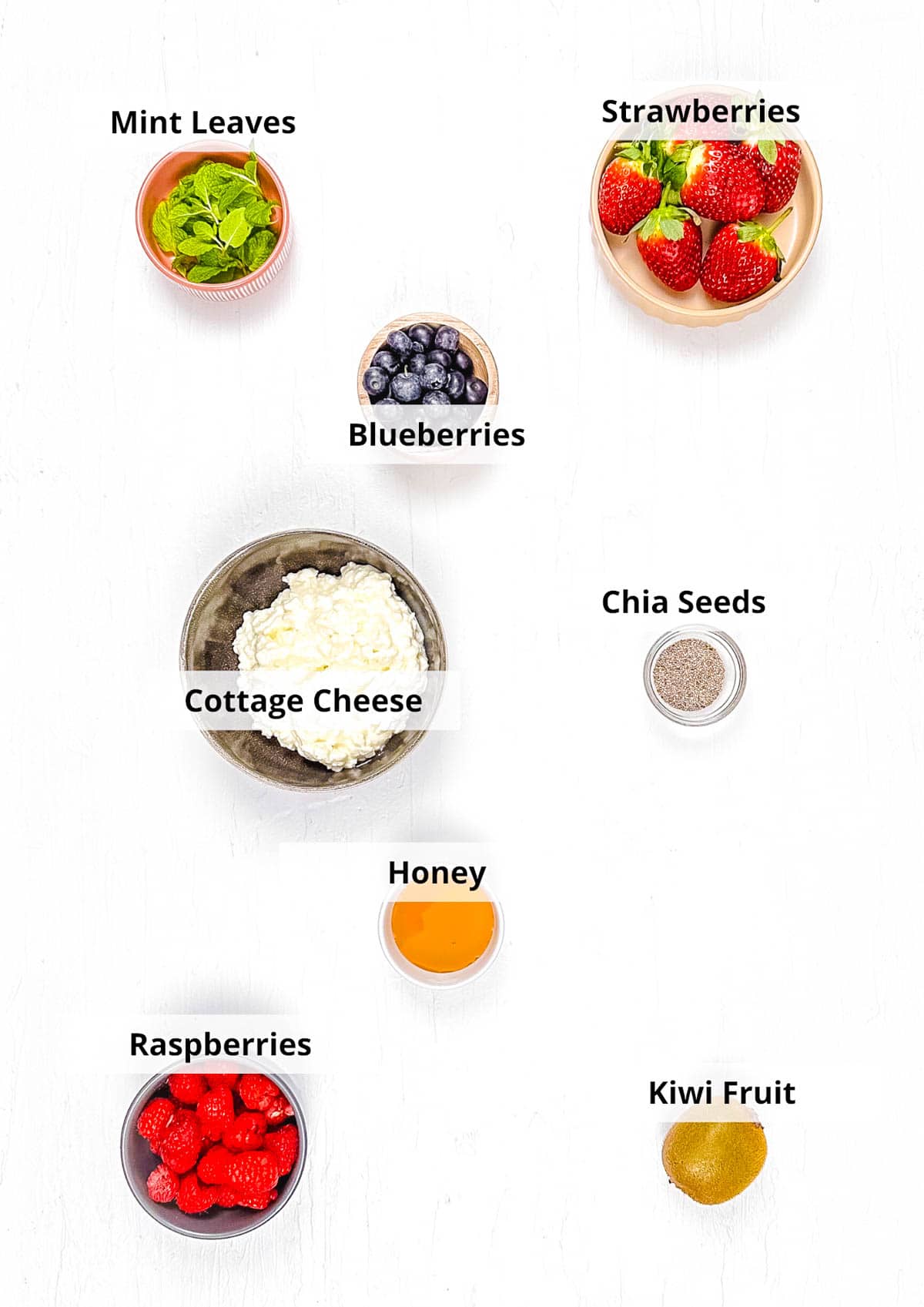 Ingredients for cottage cheese with fruit recipe on a white background.