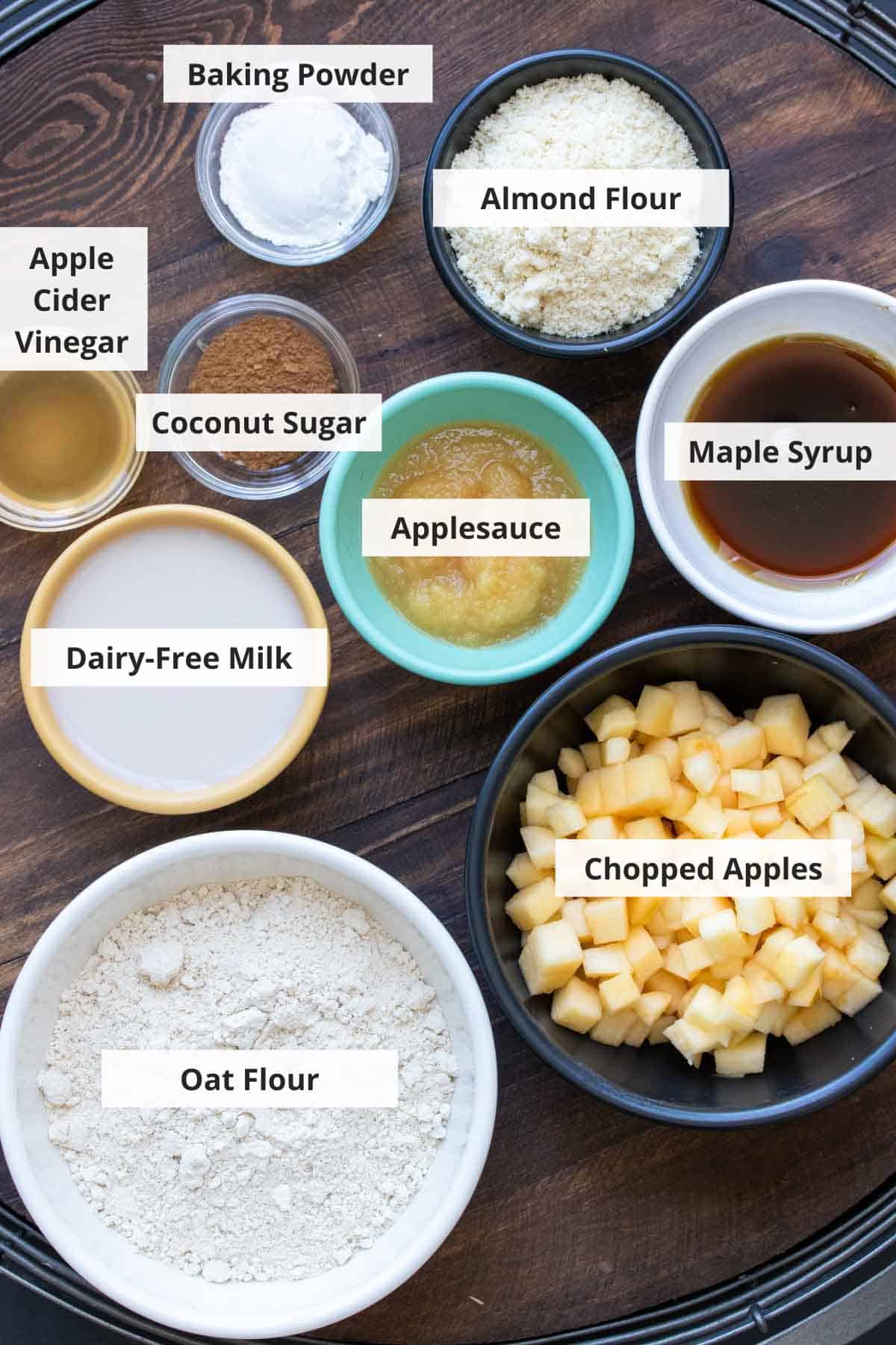 Ingredients for healthy vegan apple muffins recipe on a wood background.