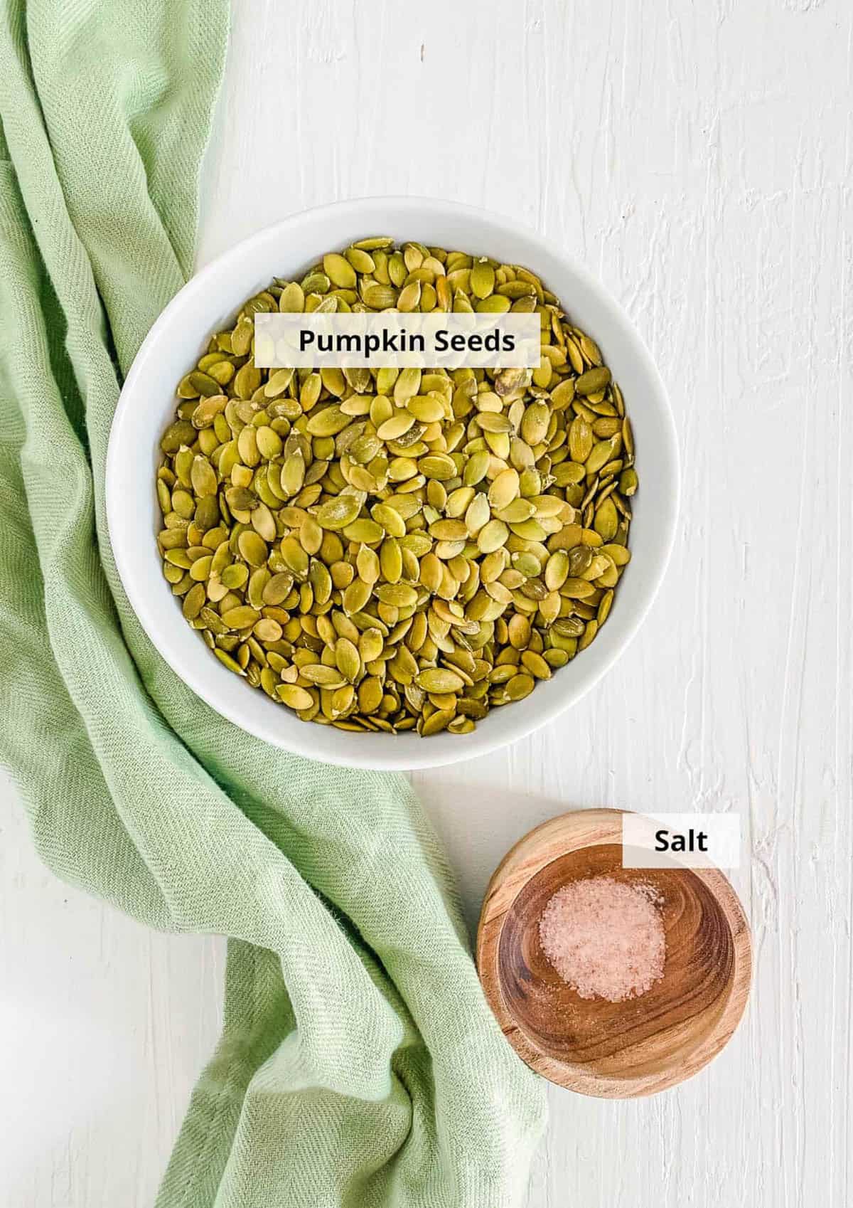 Ingredients for easy pumpkin seed butter recipe on a white background.