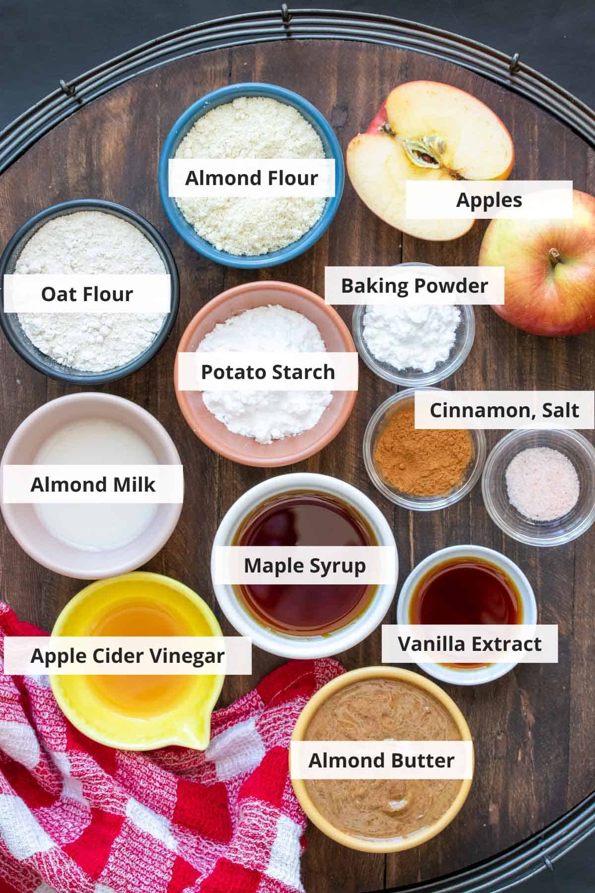 Ingredients for vegan apple cobbler recipe on a wood background.