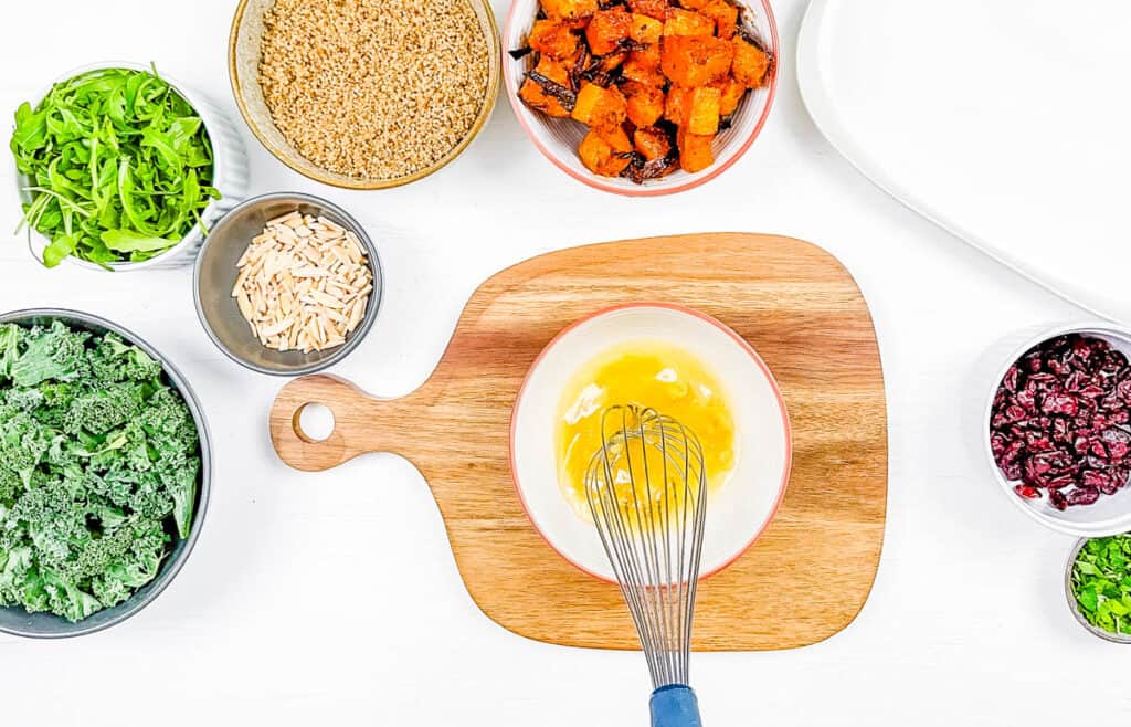 Salad dressing ingredients mixed in a mixing bowl.