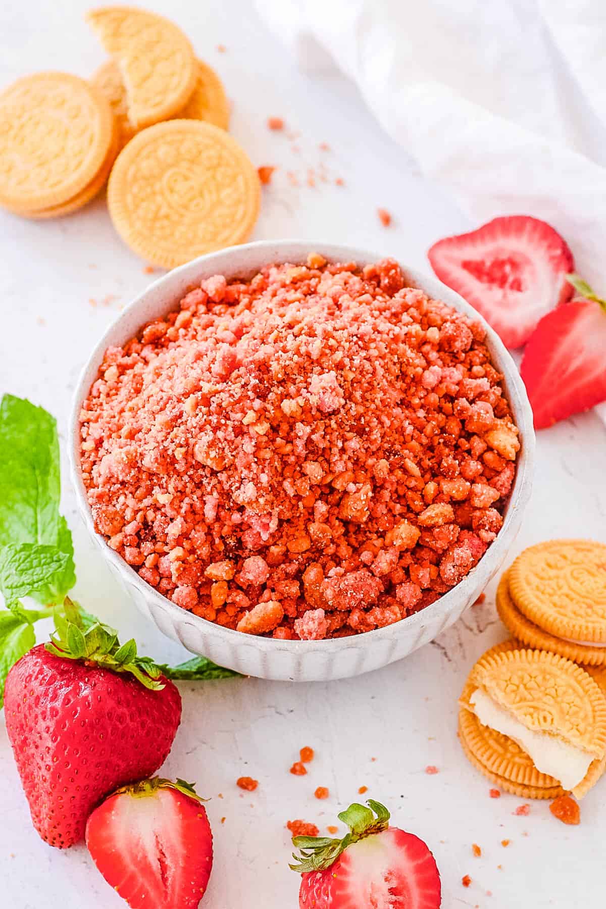 Homemade strawberry crunch topping served in a white bowl.