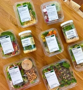 Boxes of Thistle meals on a wooden countertop.