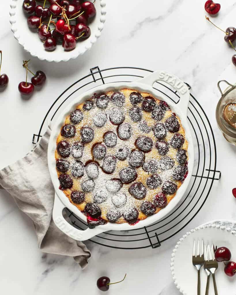 Vegan cherry clafoutis in a white baking dish.