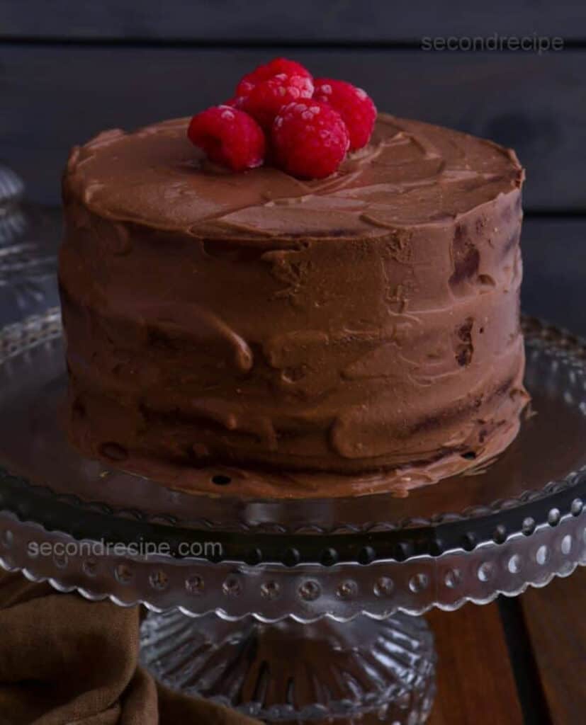 Vegan tofu chocolate cake on a cake stand.