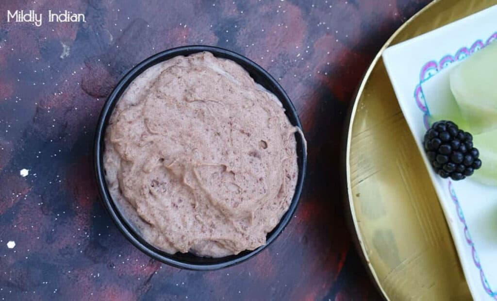 Chocolate tofu whip in a black bowl.