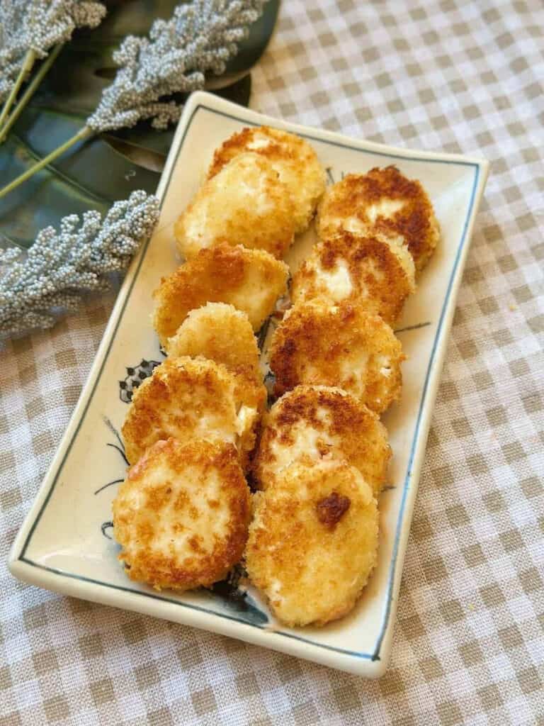 Fried silken tofu in a white serving dish.