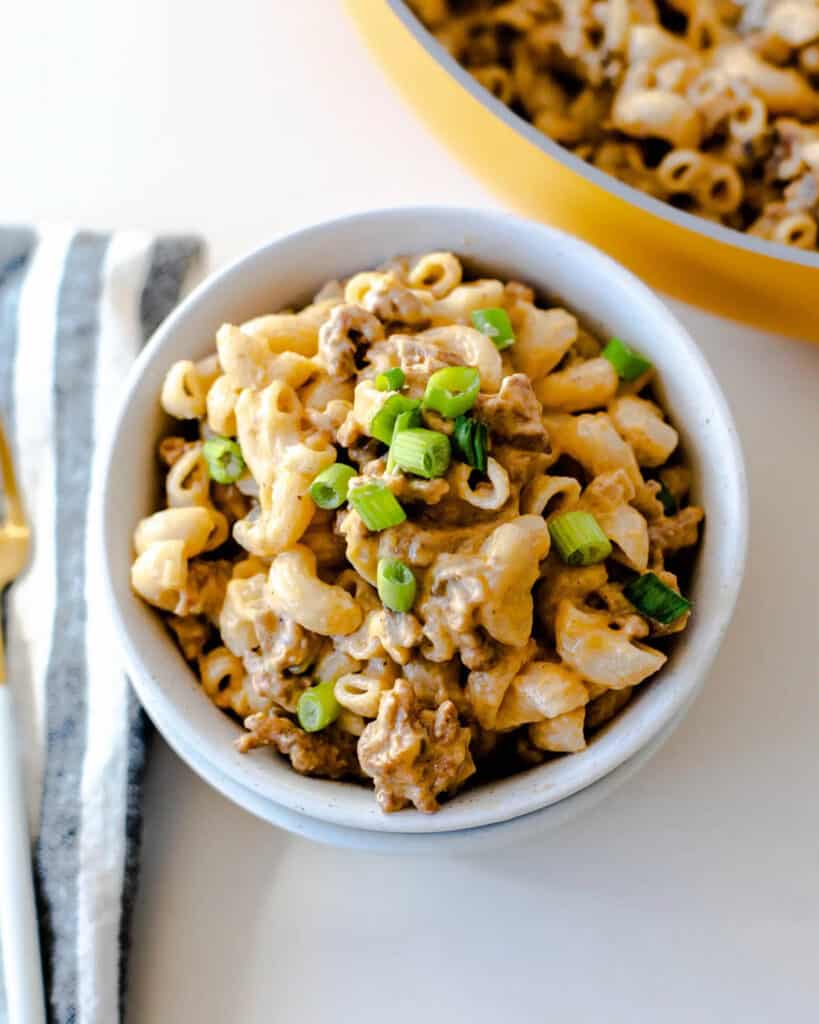 Chorizo mac and cheese with a silken tofu sauce in a white bowl.