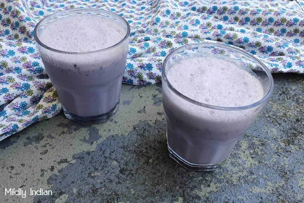 Blackberry smoothie in a glass cup.