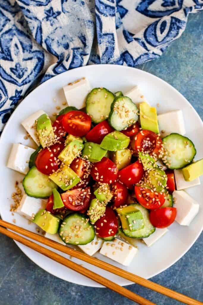 Silken tofu salad with avocado, tomatoes, cucumber, and sesame seeds.