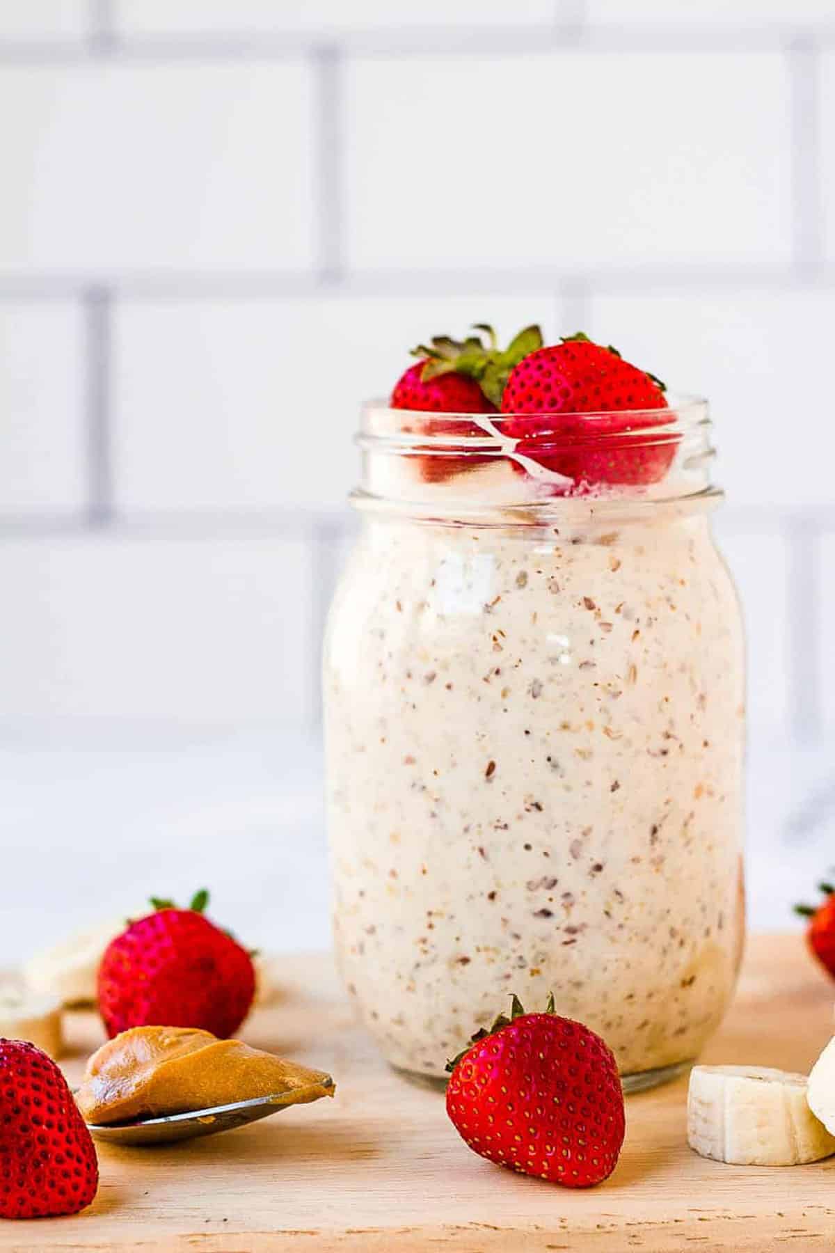 Overnight oats in a mason jar topped with strawberries.