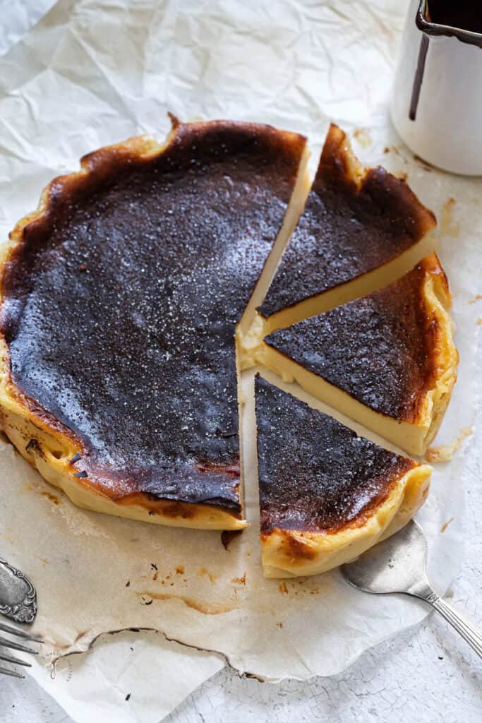 Burnt basque cheesecake on a white countertop.