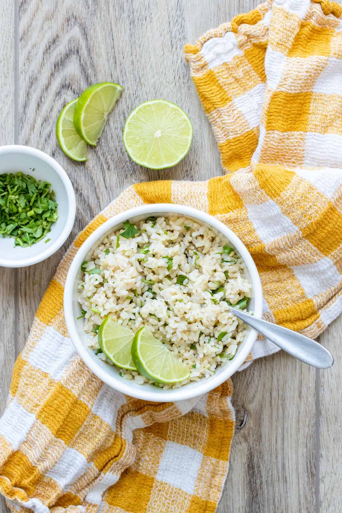 Yellow and white checkered towel with a white bowl of cilantro lime rice on it