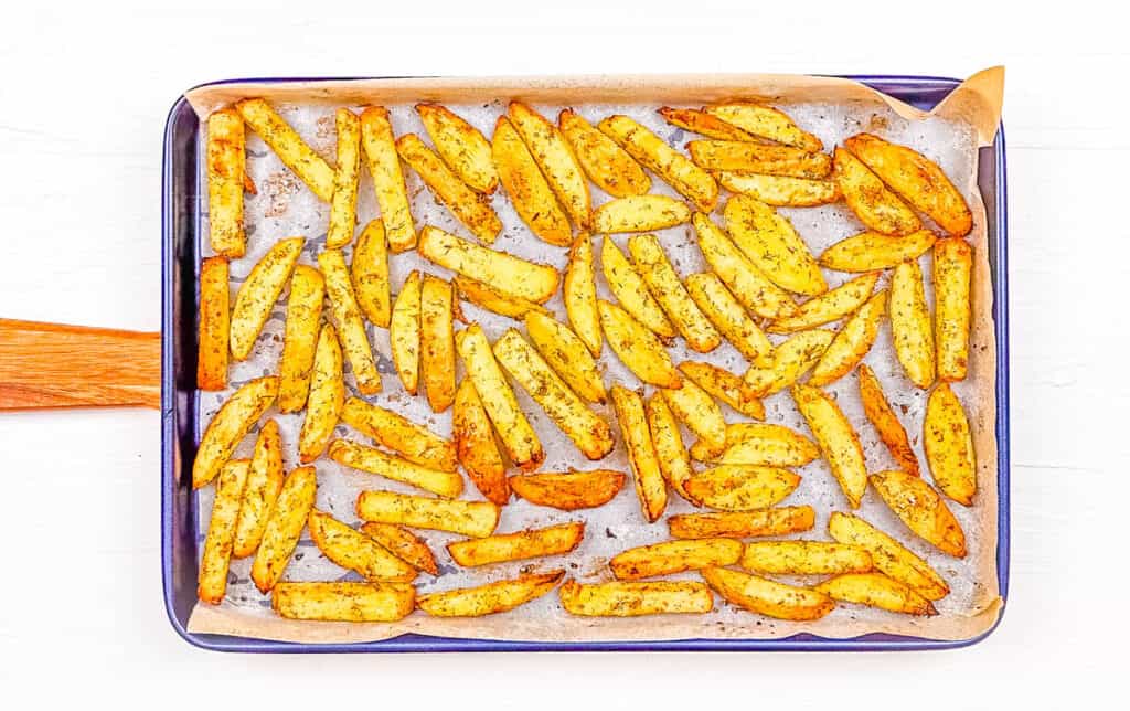 Greek seasoned fries, on a baking sheet, fresh out of the oven.