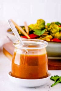 Low calorie stir fry sauce, served in a glass jar with a spoon.