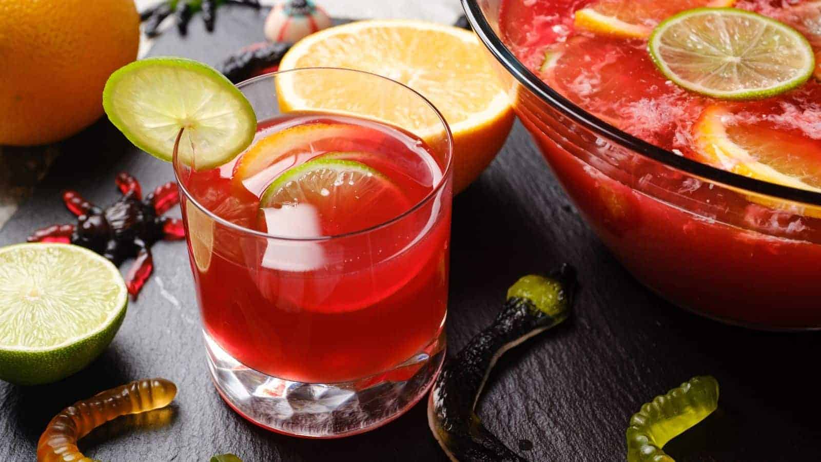 Hocus pocus punch served in a glass with a lime wedge.