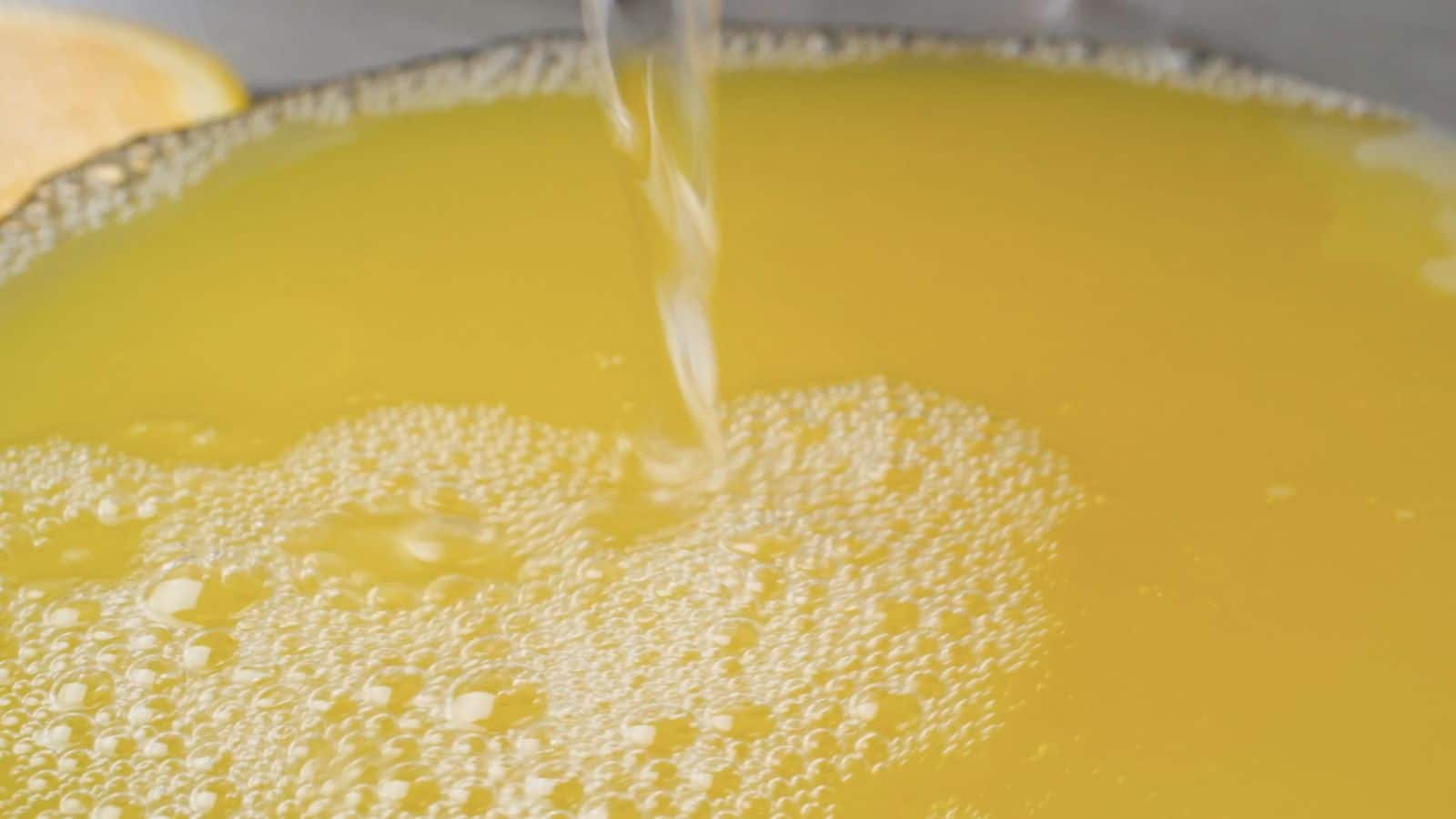 Adding lime soda to juice in punch bowl.