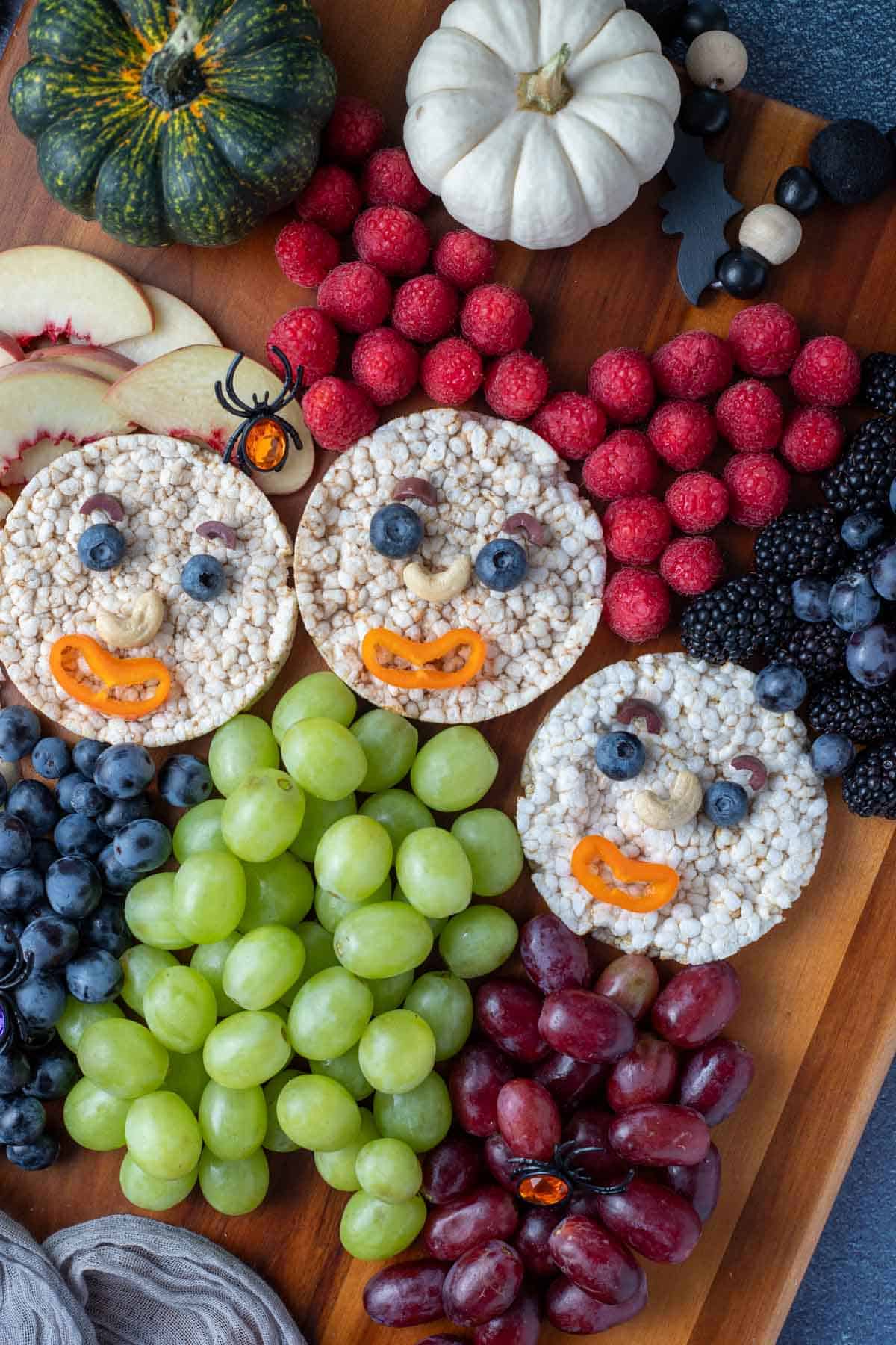 Hocus Pocus snack board: Sanderson Sisters made with rice cakes and fruit.