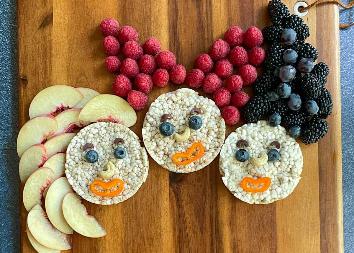 Rice cake faces with fruit har made to look like the Hocus Pocus witches.