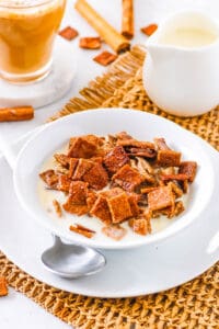 Healthy homemade cinnamon toast crunch cereal, served in a bowl with milk.
